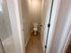 Neutral-toned powder bath featuring wood-look tile and a toilet at 4524 Sw 110Th St, Ocala, FL 34476