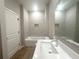 Bright bathroom with a shower-tub, tiled walls, a recessed wall niche, and sleek vanity with modern fixtures at 4524 Sw 110Th St, Ocala, FL 34476