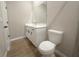 Bright bathroom featuring a white vanity and toilet with neutral wall and floor tiles at 4524 Sw 110Th St, Ocala, FL 34476