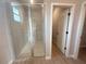 Beautiful bathroom with glass shower, neutral tile and door to hallway at 4524 Sw 110Th St, Ocala, FL 34476