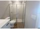Full bathroom featuring a toilet and tiled shower with glass door at 4524 Sw 110Th St, Ocala, FL 34476