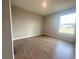 A sunlit bedroom features tile flooring, neutral paint, and a window overlooking the outdoors at 4524 Sw 110Th St, Ocala, FL 34476