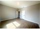 Bedroom with wood-look tile, neutral walls, and a double-door closet at 4524 Sw 110Th St, Ocala, FL 34476