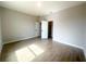 Primary bedroom with neutral colors, wood-look tile, and 2 doors at 4524 Sw 110Th St, Ocala, FL 34476
