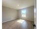 A well-lit bedroom features tile flooring, neutral paint, and a window that brings in the sunlight at 4524 Sw 110Th St, Ocala, FL 34476