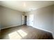 Neutral primary bedroom with wood-look tile flooring and two doors at 4524 Sw 110Th St, Ocala, FL 34476