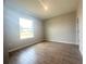 A sunlit bedroom features tile flooring, neutral paint, and a window overlooking the outdoors at 4524 Sw 110Th St, Ocala, FL 34476