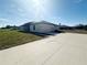 A side view of this new home highlighting the ample yard, driveway, and attached garage at 4524 Sw 110Th St, Ocala, FL 34476