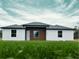 Beautiful single-story home boasting a modern design, fresh green grass, and a well-manicured lawn at 4524 Sw 110Th St, Ocala, FL 34476