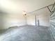 Spacious garage with concrete floor, garage door, and an installed water heater at 4524 Sw 110Th St, Ocala, FL 34476