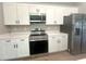 Modern kitchen featuring stainless steel appliances, white cabinets, and quartz countertops at 4524 Sw 110Th St, Ocala, FL 34476