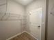 Walk-in closet featuring wire shelving, neutral walls, and wood-look tile at 4524 Sw 110Th St, Ocala, FL 34476