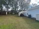 Backyard with trees, shed, and lean-to with yard waste at 4580 Sw 110Th Ln, Ocala, FL 34476