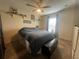 Cozy bedroom with a ceiling fan, window, light-colored walls and wall shelves at 4580 Sw 110Th Ln, Ocala, FL 34476