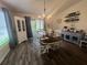 Cozy dining room featuring a stylish chandelier and sliding door access to the lanai at 4580 Sw 110Th Ln, Ocala, FL 34476