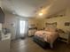 Comfortable main bedroom features wood floors, a ceiling fan, and natural light at 4580 Sw 110Th Ln, Ocala, FL 34476