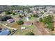 An aerial view of the home with its large, well-maintained lawn with a convenient storage shed and car port at 4858 Sw 143Rd Loop, Ocala, FL 34473