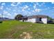 Expansive backyard space with lush green grass, perfect for outdoor activities and relaxation with screened in porch at 4858 Sw 143Rd Loop, Ocala, FL 34473