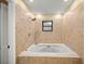 Bathroom with a jetted tub and tiled walls at 5205 Ne 3Rd St, Ocala, FL 34470