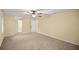 Spacious bedroom with neutral paint and carpet, leading to closet and bath at 5205 Ne 3Rd St, Ocala, FL 34470