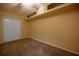 Bedroom with neutral carpet, bright yellow walls, and white closet doors at 5205 Ne 3Rd St, Ocala, FL 34470