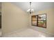 Bright dining area featuring neutral walls, tiled floor, and a large window with lush landscaping view at 5205 Ne 3Rd St, Ocala, FL 34470