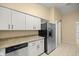 Modern kitchen with white cabinetry, stainless steel appliances, and granite countertops at 5205 Ne 3Rd St, Ocala, FL 34470