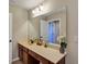 Bathroom featuring vanity with stone countertop, bronze fixtures, and open door at 5417 Sw 49Th Ave, Ocala, FL 34474