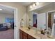 Bathroom featuring double sink vanity with granite countertop and bronze fixtures at 5417 Sw 49Th Ave, Ocala, FL 34474