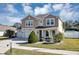 Charming two-story home with three-car garage, manicured lawn, and a welcoming exterior design at 5417 Sw 49Th Ave, Ocala, FL 34474