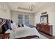 Bright main bedroom featuring hardwood floors, a chandelier, and two large windows at 5417 Sw 49Th Ave, Ocala, FL 34474