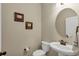 Cozy half bathroom features a pedestal sink, round mirror, and decorative wall art at 5417 Sw 49Th Ave, Ocala, FL 34474