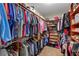 Spacious walk-in closet with wooden shelving, providing ample storage for clothes and accessories at 5417 Sw 49Th Ave, Ocala, FL 34474