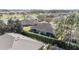 An aerial view reveals the home's screened lanai, landscaping, and nearby pond at 6780 Sw 91St Cir, Ocala, FL 34481