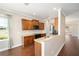 Kitchen with granite countertops and wood cabinets overlooking dining area at 6780 Sw 91St Cir, Ocala, FL 34481