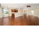 Living room with hardwood floors, adjacent to the open-concept kitchen at 6780 Sw 91St Cir, Ocala, FL 34481