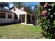 Back view of the home from yard with flower bush at 7972 Midway Drive Ter # O103, Ocala, FL 34472