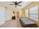 Bright bedroom featuring a ceiling fan, closet, and natural light streaming through two windows at 7972 Midway Drive Ter # O103, Ocala, FL 34472