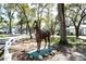 Exterior shot of the property showcasing horse statue and white picket fences at 7972 Midway Drive Ter # O103, Ocala, FL 34472