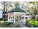 Exterior shot of the community gazebo featuring patriotic decor and outdoor seating at 7972 Midway Drive Ter # O103, Ocala, FL 34472