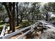 A view down a residential street, bordered by a white fence, with houses and mature trees at 7972 Midway Drive Ter # O103, Ocala, FL 34472