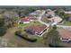 Aerial perspective of single-Gathering homes with lanais and colorful roofs nestled among mature trees at 8223 Sw 113Th Ln, Ocala, FL 34481