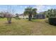 Spacious lawn featuring a palm tree and a screened in lanai at 8223 Sw 113Th Ln, Ocala, FL 34481