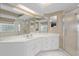 Bathroom with white vanity, quartz countertop, shower, and window at 8223 Sw 113Th Ln, Ocala, FL 34481