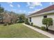 A low angle shot of the lawn and exterior of a home on a bright sunny day at 8223 Sw 113Th Ln, Ocala, FL 34481