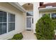 Inviting front entrance with decorative security door, manicured bushes and an arched entryway at 8223 Sw 113Th Ln, Ocala, FL 34481