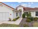 A charming home with a terracotta roof, manicured bushes, and a walkway leading to the front door at 8223 Sw 113Th Ln, Ocala, FL 34481