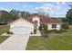 Charming home with a red tile roof, well-manicured landscaping, and an inviting front entrance at 8223 Sw 113Th Ln, Ocala, FL 34481