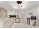 Bright and airy kitchen with stainless steel appliances, white cabinetry, and tile flooring at 8223 Sw 113Th Ln, Ocala, FL 34481