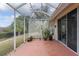 Covered patio shot with concrete flooring, a light, and view of a manicured lawn at 8223 Sw 113Th Ln, Ocala, FL 34481